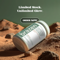 Brazen grass fed protein powder container on a rocky surface with promotional text.